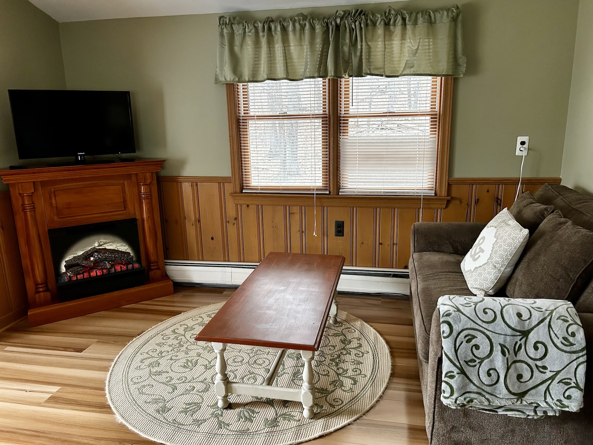 The Taylor Thompson Room Loveseat, TV, and Fireplace