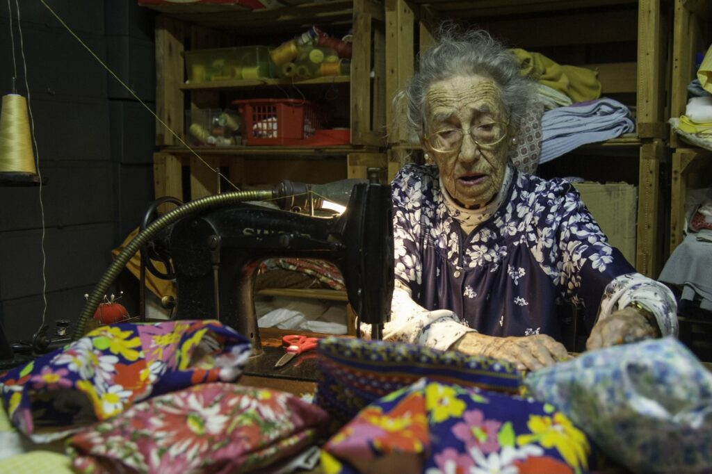 Ann Wallerstein Sewing Pillows In Front of Her Sewing Machine