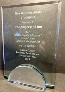 Glass award that reads New Business Award Presented To The Ampersand Inn For Outstanding Contribution To Sussex County Economic Development Sussex County Economic Development Partnership, Inc. 2024