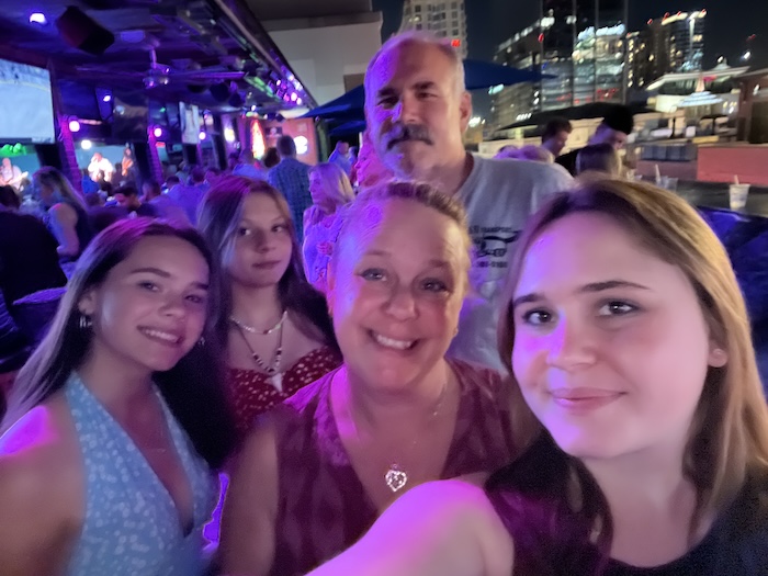 Isobel, Olivia, Magdalen, and their parents Dawn & John smiling