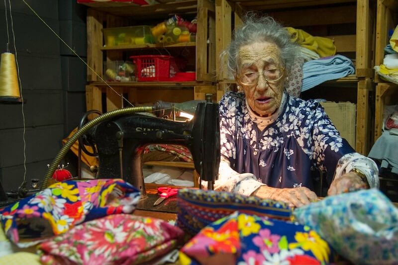 Ann Wallerstein sewing at her Singer sewing machine