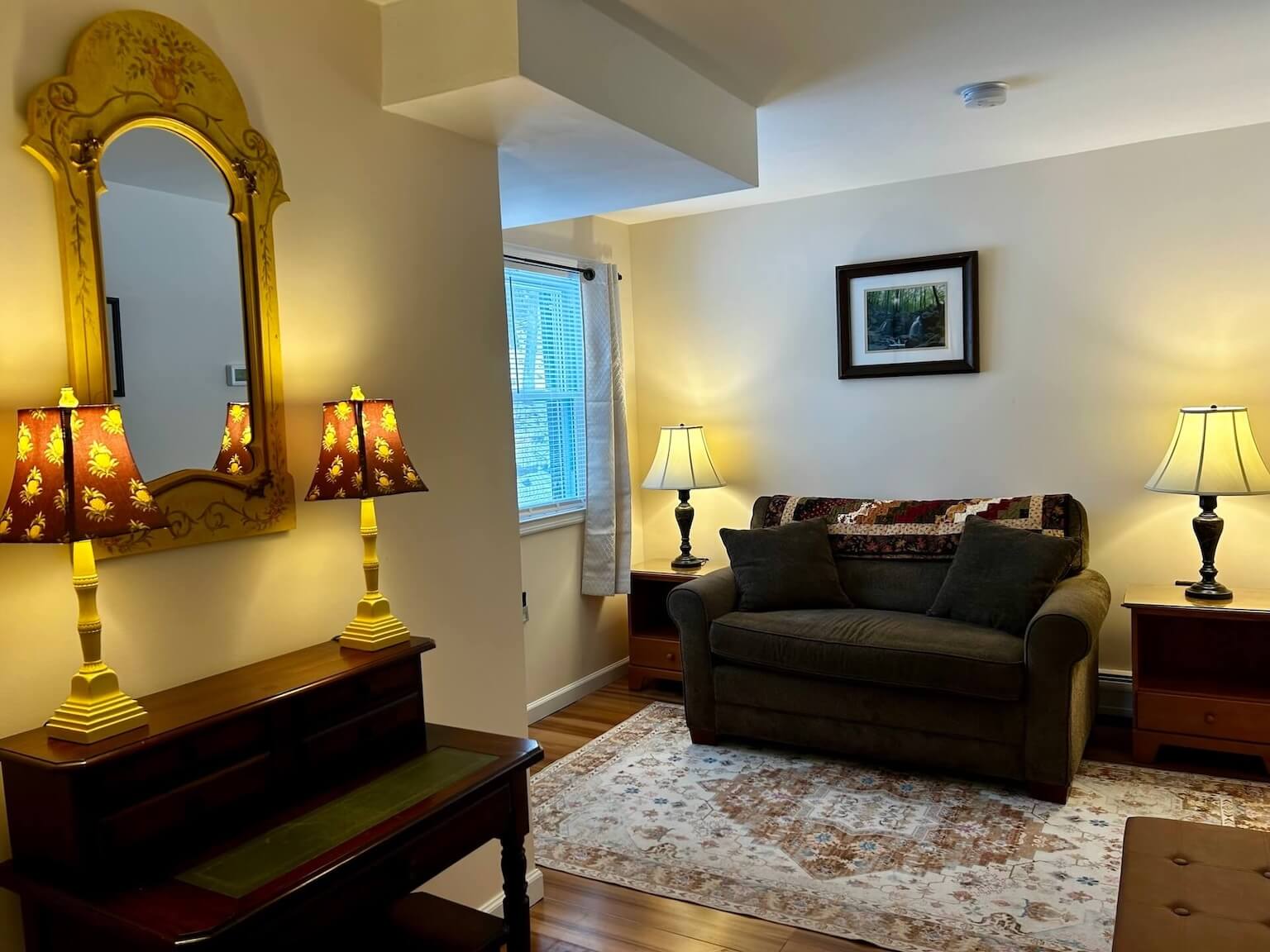 Room 8 Living Area featuring two beige chairs, a coffee table, an electric fireplace, and television.