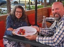 Two guests celebrating with a complimentary dessert through the Ampersand Advantage program.