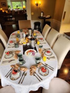 One of our dining tables set with a fruit bowl, juice, and coffee (first course).