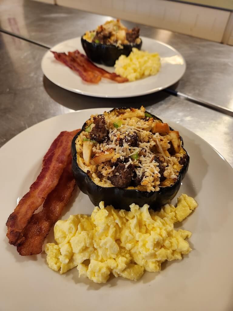 Stuffed squash, scrambled eggs, and bacon.